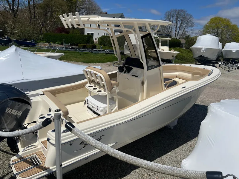 Slide: The Image of 2024 Scout 215 XSF boat with Yamaha engine on display outdoors. - 1