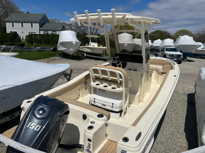 Slide: The Image of 2024 Scout 215 XSF boat with Yamaha 150 engine in a marina. - 2