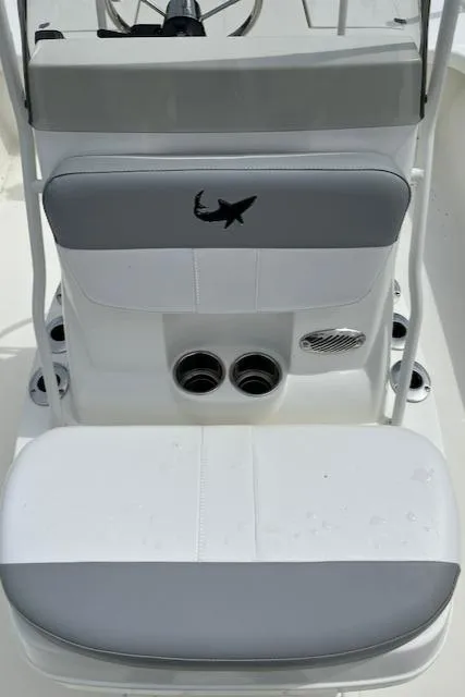 Slide: The Image of 2024 Mako 18 LTS boat seating and console with shark logo. - 11