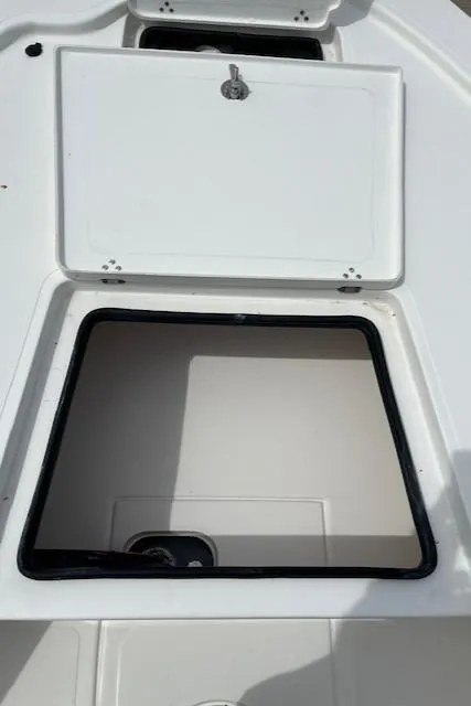 Slide: The Image of Open storage compartment on a 2024 Mako 18 LTS boat. - 12