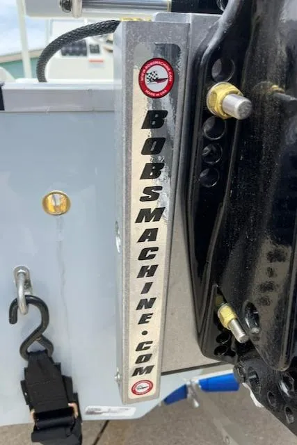 Slide: The Image of Close-up of a 2024 Mako 18 LTS boat engine mount with Bobsmachine.com branding. - 15
