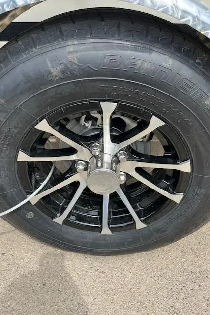 Slide: The Image of 2024 Mako 18 LTS trailer wheel with black and silver alloy rim. - 18