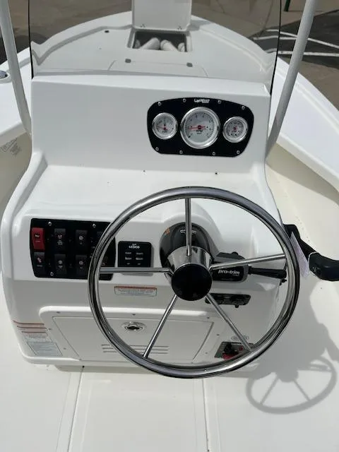 Slide: The Image of 2024 Mako 18 LTS boat console with steering wheel and control panel. - 3