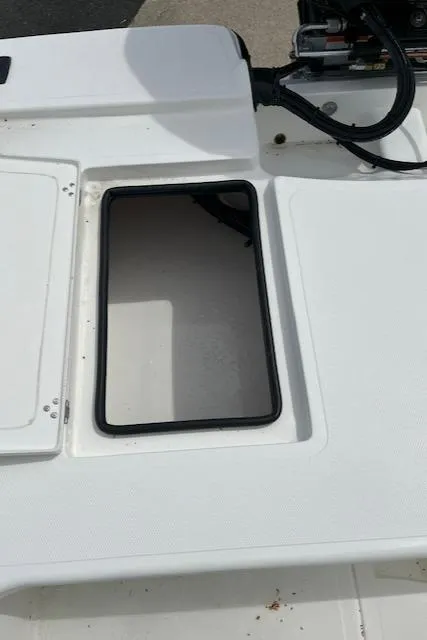 Slide: The Image of 2024 Mako 18 LTS boat storage compartment with open hatch. - 8