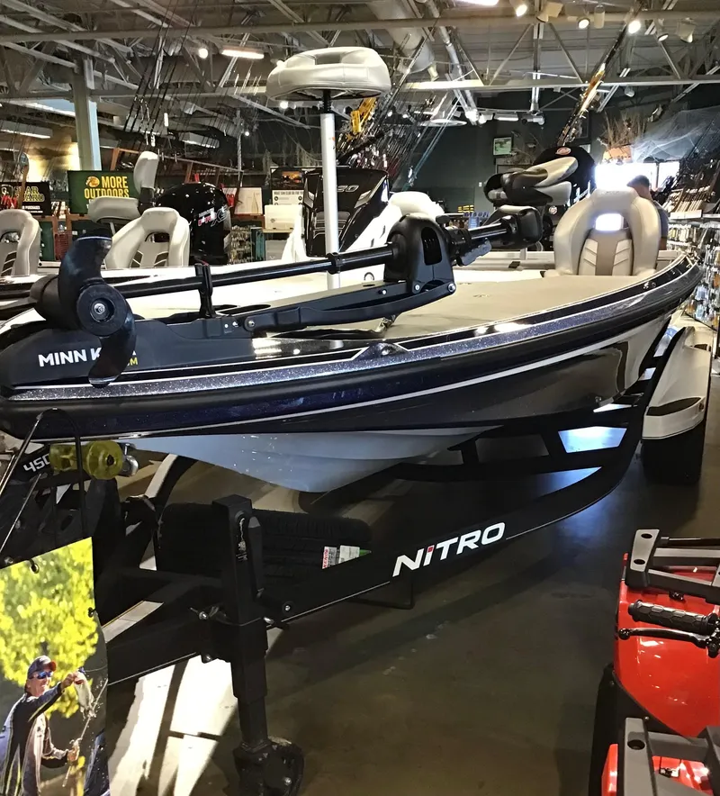 The Image of 2024 Nitro Z20 boat displayed in showroom with fishing equipment. - 0