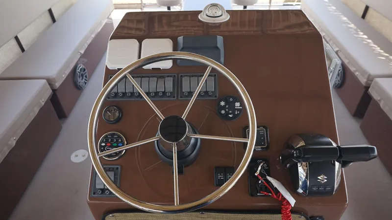 Slide: The Image of 2024 A&M Manufacturing BullDog 34 boat helm with steering wheel and controls. - 12