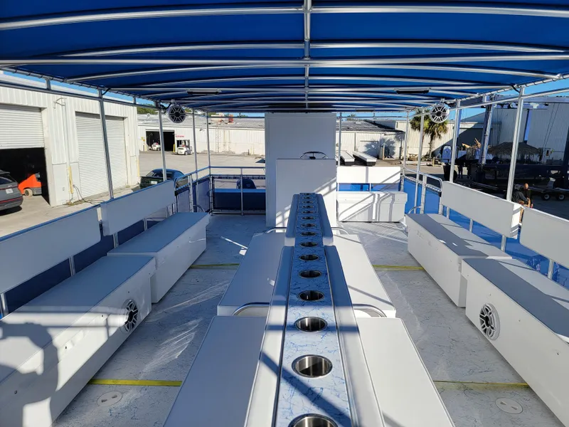 Slide: The Image of 2024 A&M Manufacturing BullDog 34 boat interior with blue canopy and seating. - 22