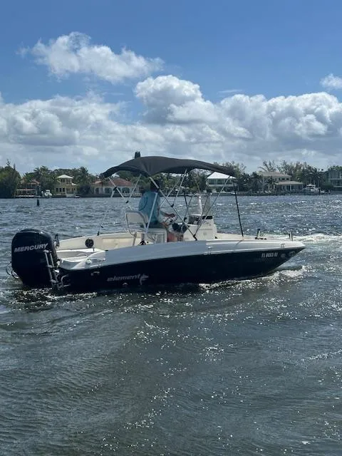 Slide: The Image of 2016 Bayliner F18 Element boat cruising on a sunny day. - 2