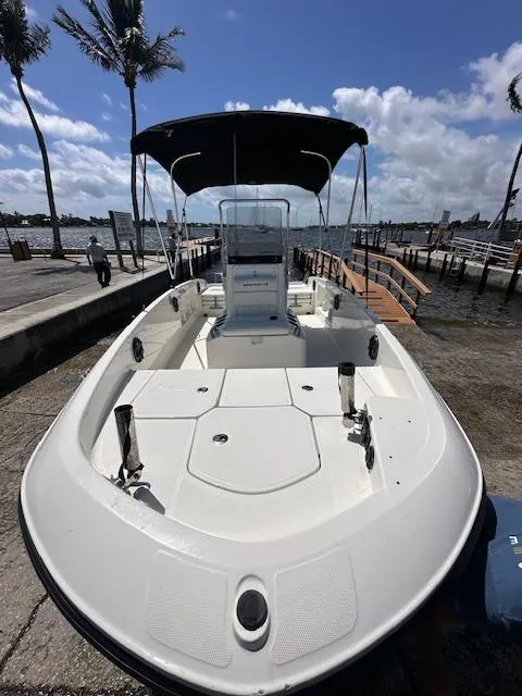 Slide: The Image of 2016 Bayliner F18 Element boat docked by the waterfront under a sunny sky. - 6