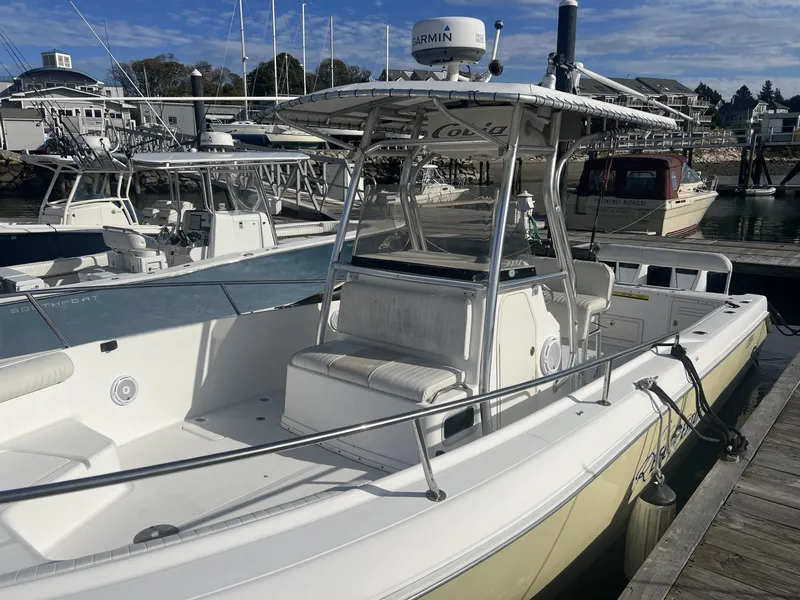 Slide: The Image of 2005 Cobia 314 Center Console boat docked at a marina on a sunny day. - 3