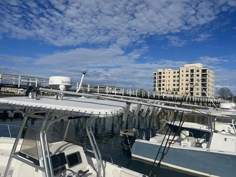 Slide: The Image of 2005 Cobia 314 Center Console boat docked at marina with clear blue sky. - 4