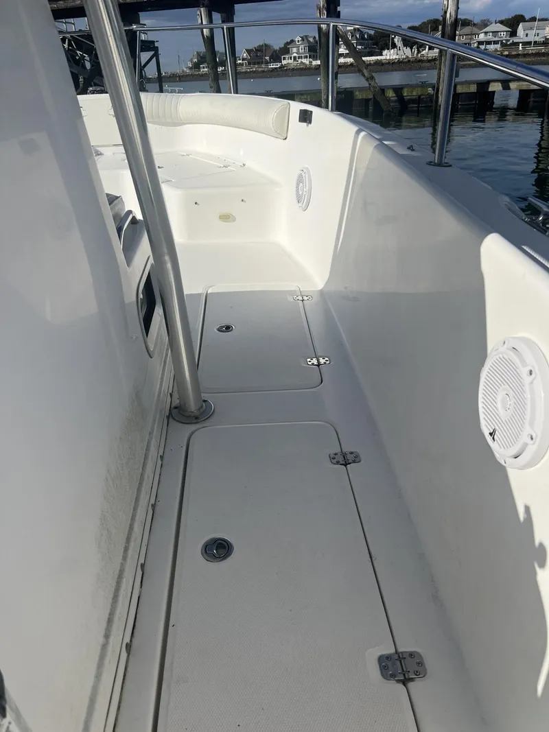 Slide: The Image of 2005 Cobia 314 Center Console boat interior, clean white deck, and seating area. - 6