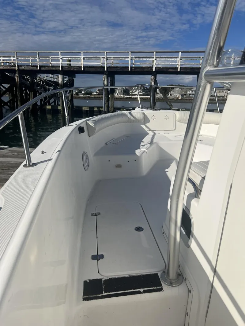 Slide: The Image of 2005 Cobia 314 Center Console boat docked near a wooden pier. - 7