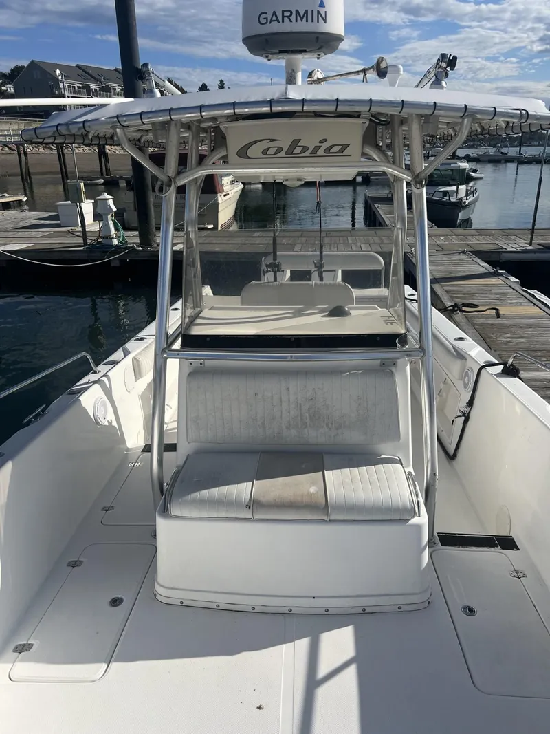 Slide: The Image of 2005 Cobia 314 Center Console boat docked at a marina. - 8