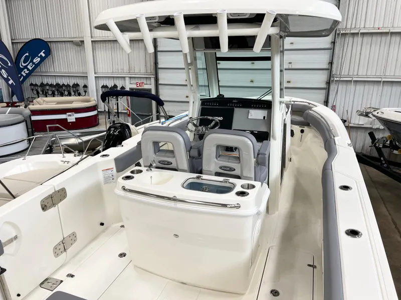 Slide: The Image of 2024 Boston Whaler 280 Outrage boat interior with dual seats and control console. - 2