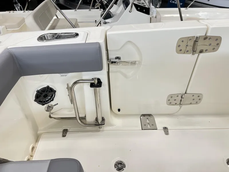 Slide: The Image of 2024 Boston Whaler 280 Outrage boat interior, featuring seating and stainless steel fixtures. - 5