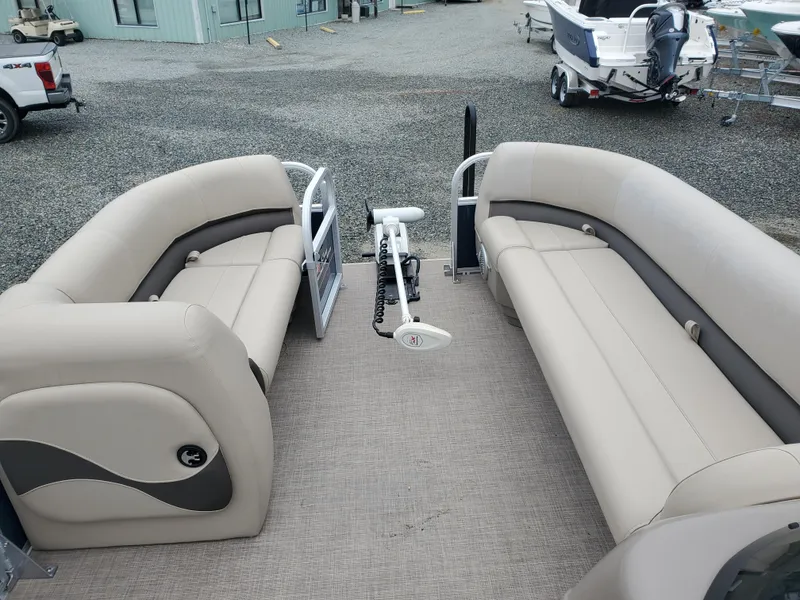 Slide: The Image of 2022 Sun Tracker Party Barge 18 DLX with beige seating, docked in a marina. - 10