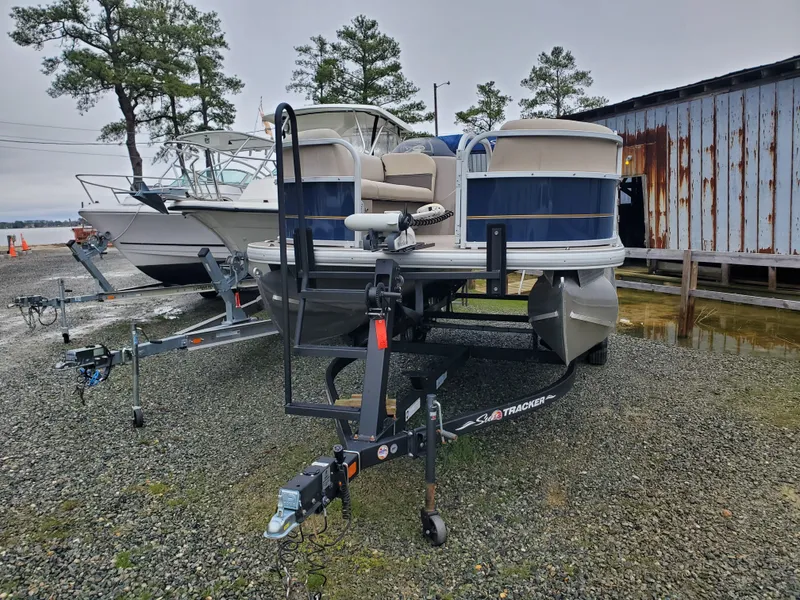 Slide: The Image of 2022 Sun Tracker Party Barge 18 DLX pontoon boat on trailer, parked outdoors. - 3