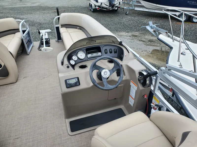 Slide: The Image of 2022 Sun Tracker Party Barge 18 DLX interior with steering console and seating. - 5