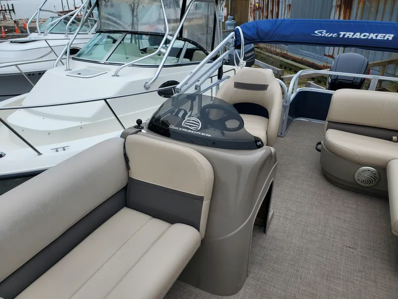 Slide: The Image of 2022 Sun Tracker Party Barge 18 DLX pontoon boat with beige seating and helm. - 7