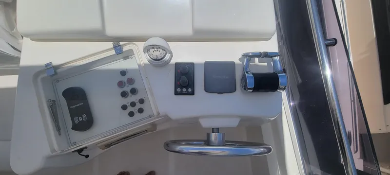 Slide: The Image of 2009 Ferretti Yachts 470 helm with steering wheel and control panel. - 13