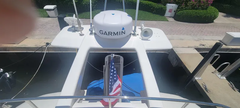 Slide: The Image of 2009 Ferretti Yachts 470 docked, featuring Garmin equipment and an American flag. - 18