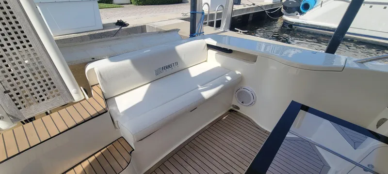 Slide: The Image of 2009 Ferretti Yachts 470 interior with white seating and teak flooring. - 26