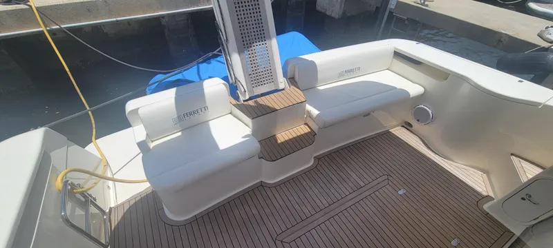 Slide: The Image of 2009 Ferretti Yachts 470 deck with seating and wooden flooring. - 27