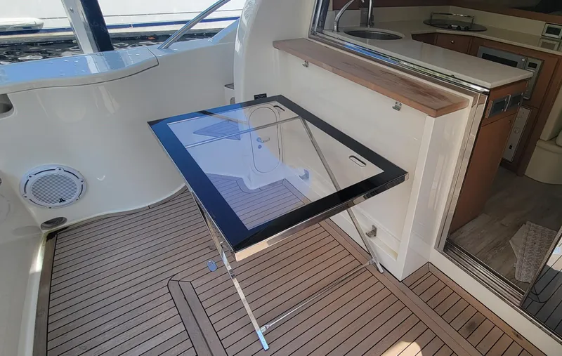 Slide: The Image of Interior of 2009 Ferretti Yachts 470 with sleek glass table and wooden flooring. - 28