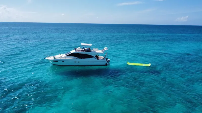 Slide: The Image of Ferretti Yachts 470 (2009) on clear blue ocean with inflatable raft nearby. - 3