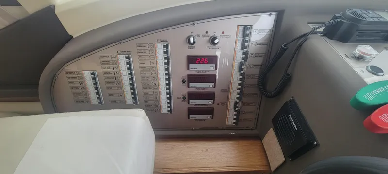 Slide: The Image of Control panel of a 2009 Ferretti Yachts 470, featuring switches and digital display. - 32