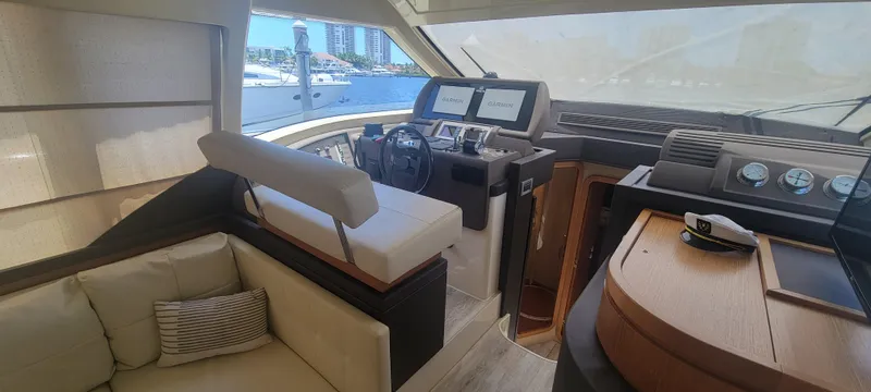 Slide: The Image of Interior of 2009 Ferretti Yachts 470, featuring helm station and seating area. - 38