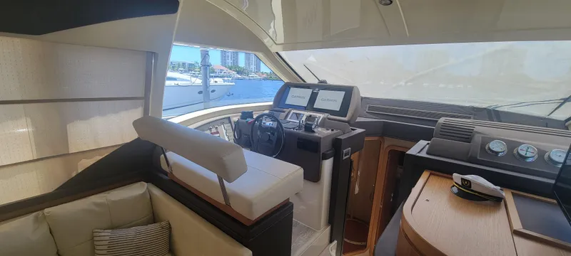 Slide: The Image of Interior of 2009 Ferretti Yachts 470, featuring helm and seating area. - 39