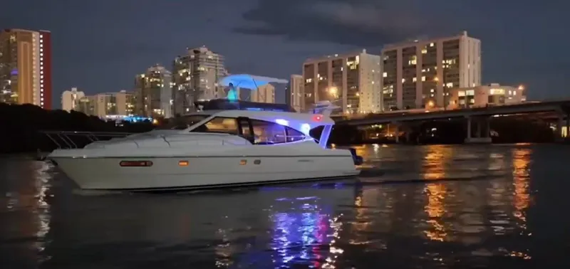 Slide: The Image of 2009 Ferretti Yachts 470 cruising at night with city skyline in the background. - 4