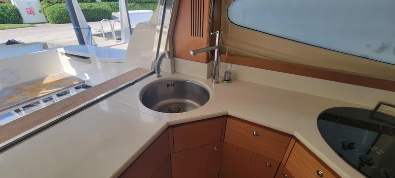Slide: The Image of Modern kitchen area on a 2009 Ferretti Yachts 470, featuring sleek countertops and a round sink. - 44