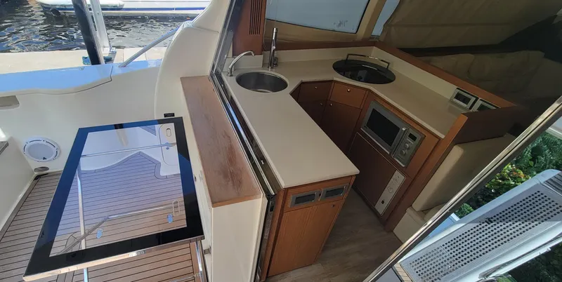 Slide: The Image of 2009 Ferretti Yachts 470 interior kitchen with modern amenities and sleek design. - 48