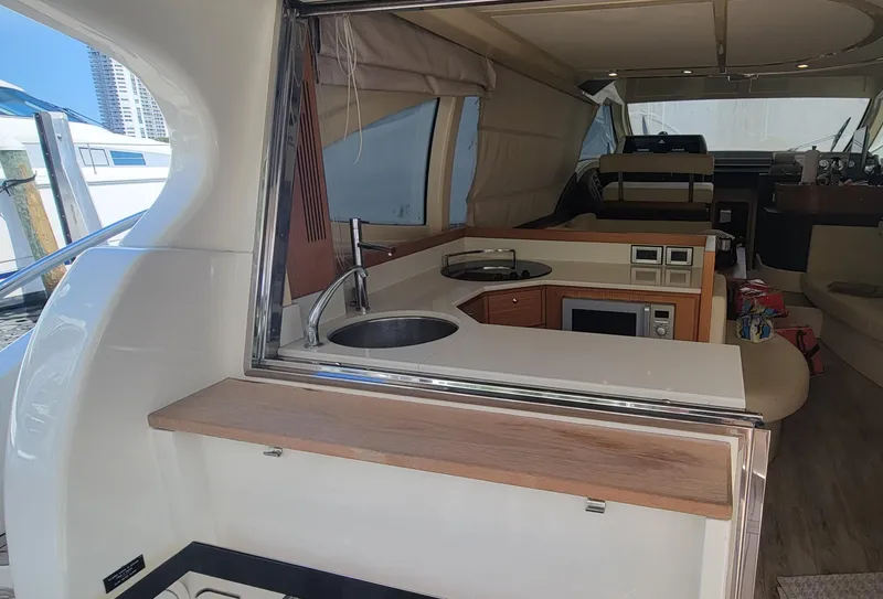 Slide: The Image of Interior view of 2009 Ferretti Yachts 470, featuring a modern kitchen area. - 49