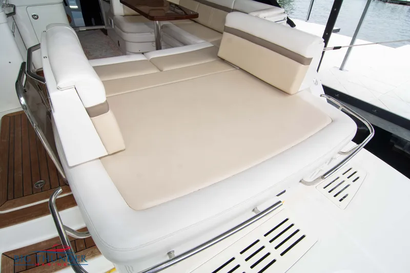 Slide: The Image of 2012 Sea Ray 410 Sundancer yacht with spacious sunbathing deck and elegant seating area. - 10