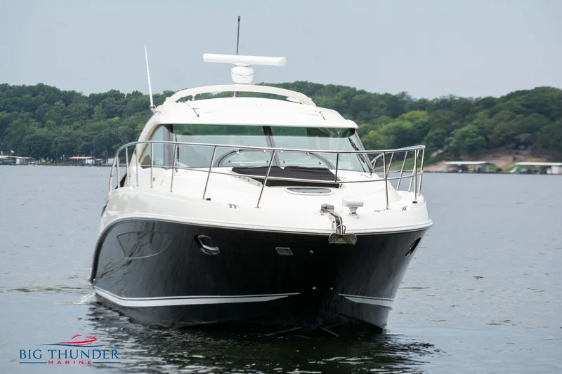 Slide: The Image of 2012 Sea Ray 410 Sundancer yacht on a calm lake. - 2