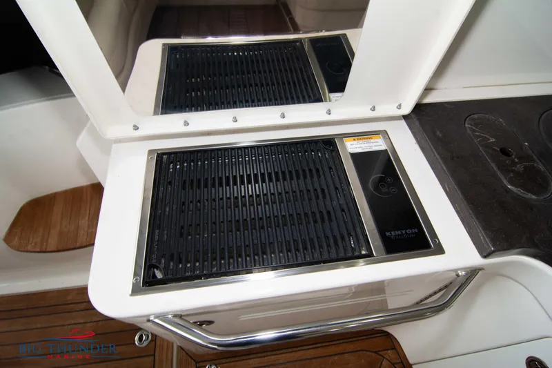 Slide: The Image of Outdoor grill on 2012 Sea Ray 410 Sundancer yacht with sleek design and wooden flooring. - 20