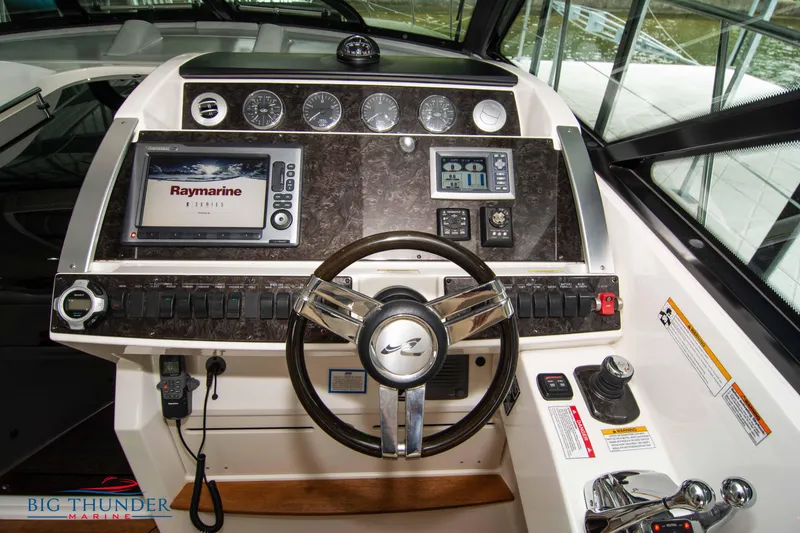 Slide: The Image of Control panel of 2012 Sea Ray 410 Sundancer yacht with navigation equipment and steering wheel. - 28