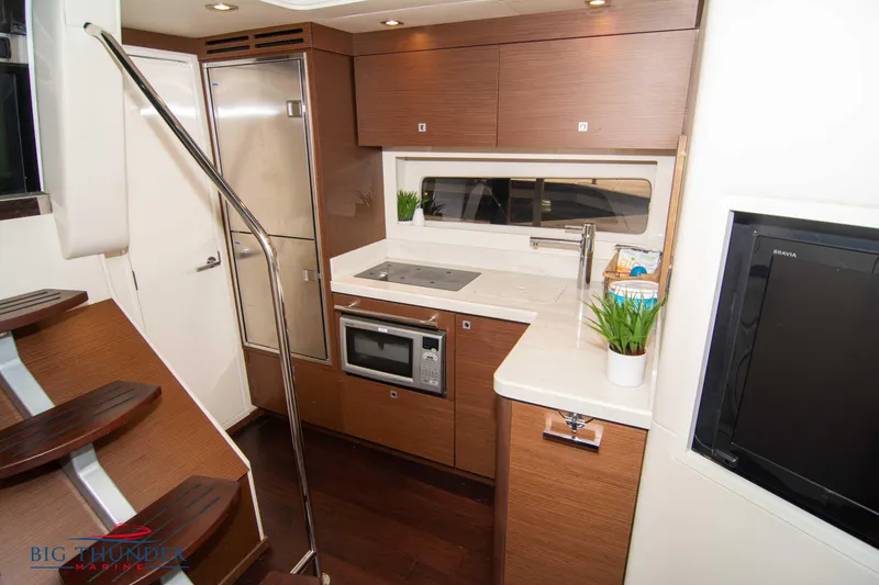 Slide: The Image of 2012 Sea Ray 410 Sundancer yacht interior with modern kitchen and sleek design. - 47