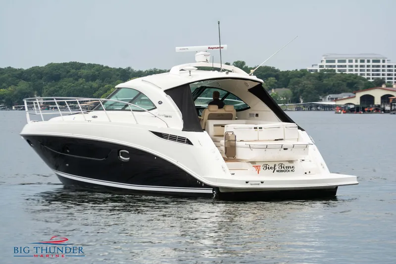 Slide: The Image of 2012 Sea Ray 410 Sundancer yacht on a calm lake. - 6
