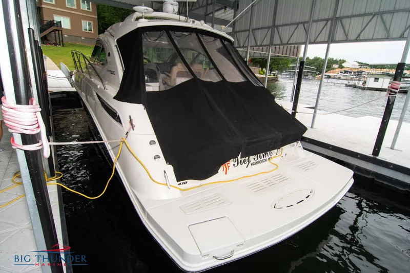 Slide: The Image of 2012 Sea Ray 410 Sundancer docked under a covered marina. - 9