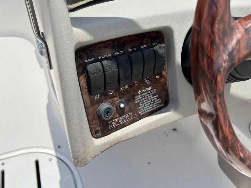 Slide: The Image of 2003 Four Winns 190 Horizon boat dashboard controls and steering wheel. - 16