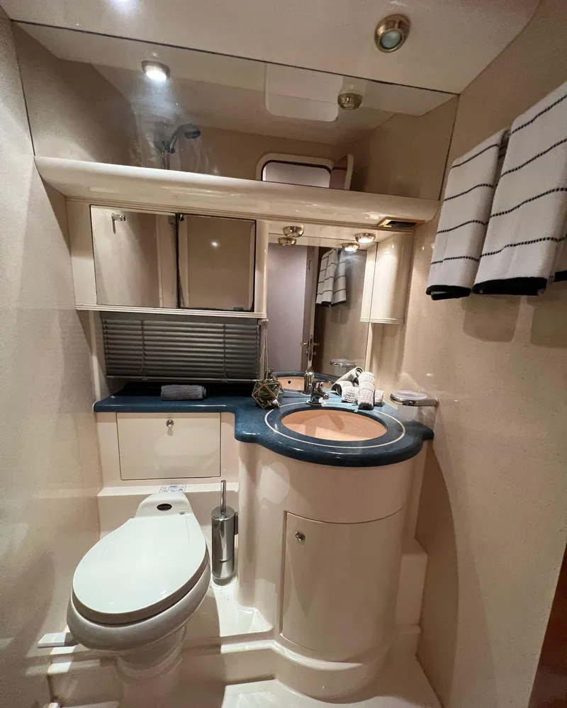 Slide: The Image of Luxurious bathroom in a 2001 Azimut 58 yacht with modern fixtures and elegant design. - 11