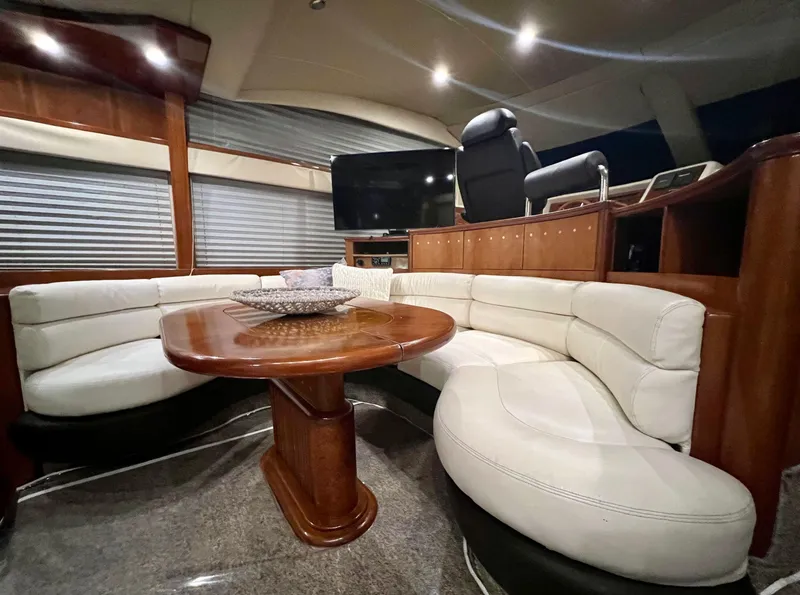 Slide: The Image of Luxurious interior of a 2001 Azimut 58 yacht with white leather seating and wooden table. - 12
