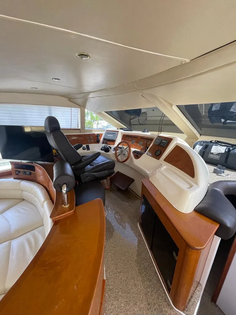 Slide: The Image of 2001 Azimut 58 yacht interior with modern helm and luxurious seating. - 15