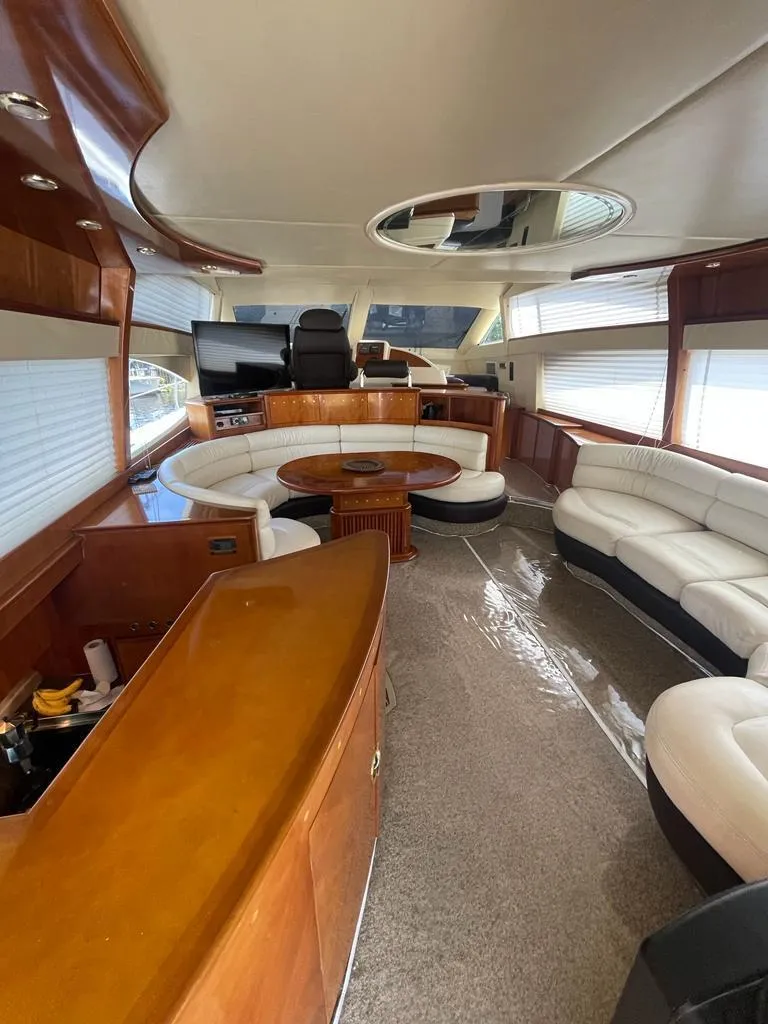 Slide: The Image of Luxurious interior of a 2001 Azimut 58 yacht with leather seating and wooden finishes. - 16