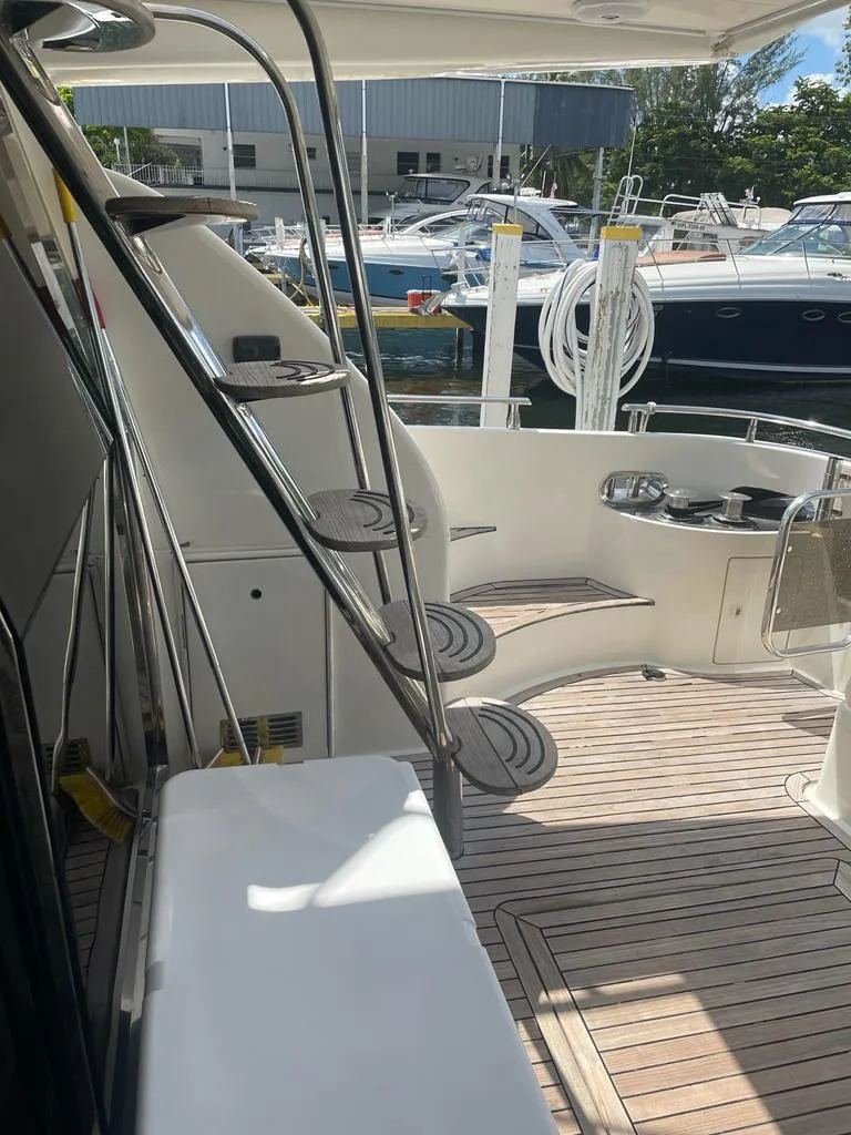 Slide: The Image of 2001 Azimut 58 yacht with teak deck and spiral staircase in marina. - 4